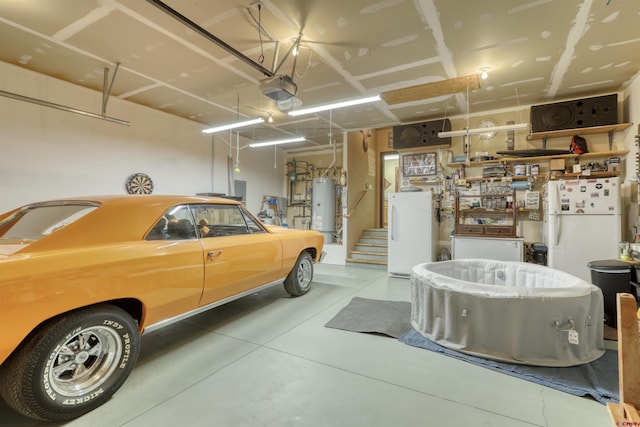 garage featuring water heater, freestanding refrigerator, and a garage door opener