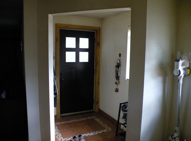 tiled foyer with baseboards