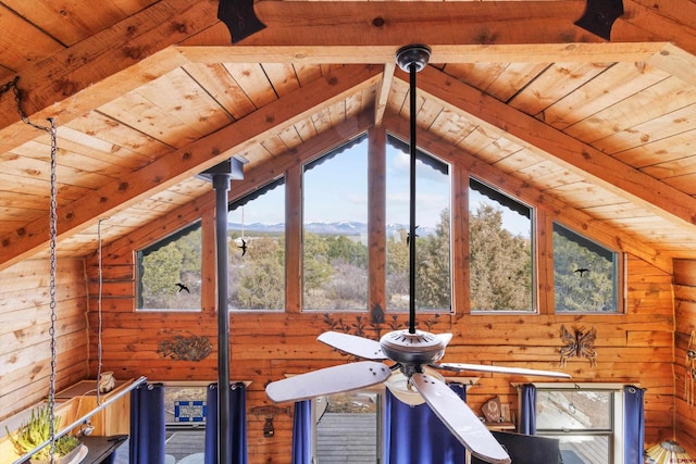 interior space featuring a mountain view, beamed ceiling, wood walls, and wood ceiling