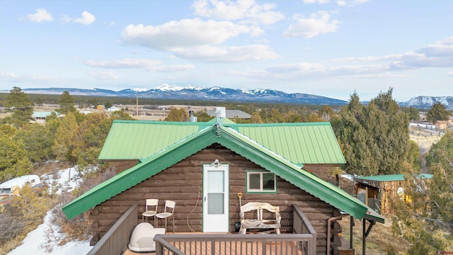 exterior space with metal roof, a mountain view, and log siding