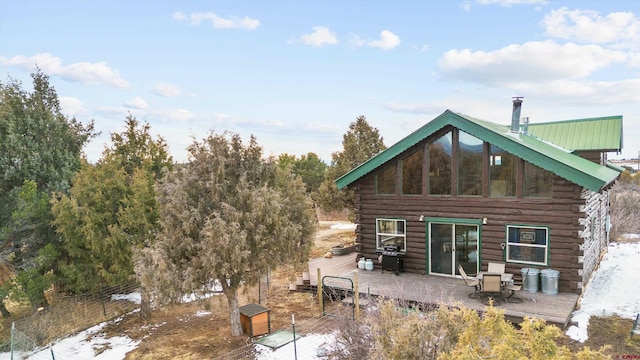 back of property featuring metal roof and log siding