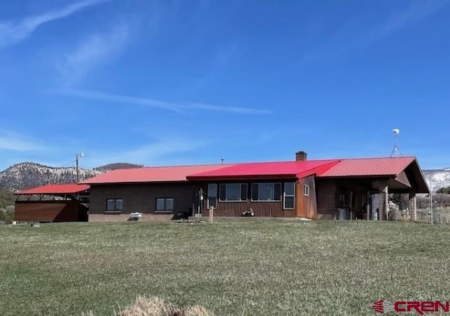 ranch-style home with a mountain view and metal roof