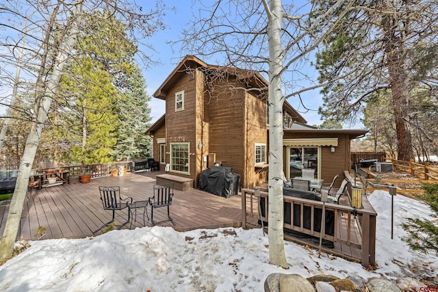 snow covered deck with fence and area for grilling