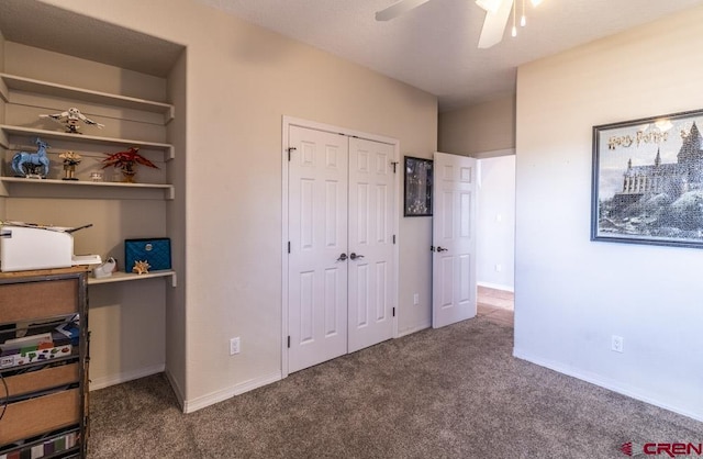 bedroom with ceiling fan, a closet, carpet flooring, and baseboards