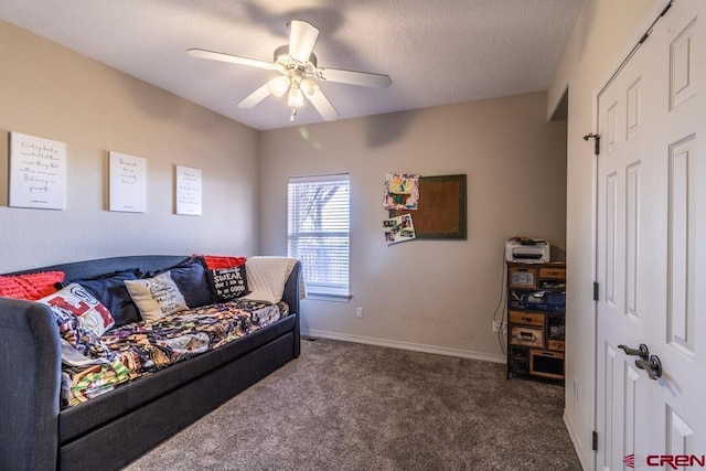 living area featuring carpet, ceiling fan, a textured ceiling, and baseboards