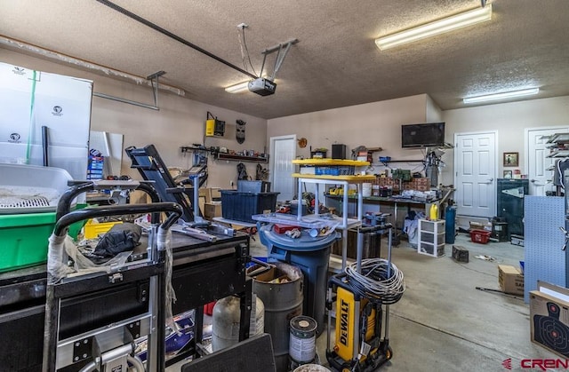 garage with a workshop area and a garage door opener