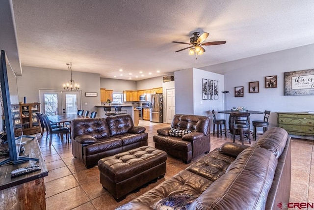 living room featuring light tile patterned floors, recessed lighting, a textured ceiling, and ceiling fan with notable chandelier