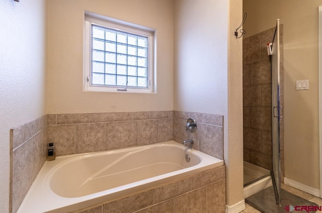 bathroom with a stall shower and a bath