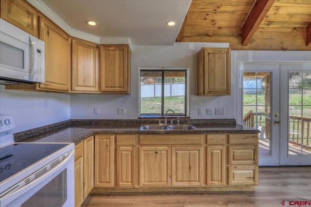 kitchen with french doors, recessed lighting, light wood-style floors, a sink, and white appliances