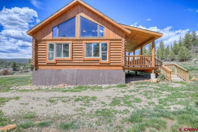 view of side of home featuring log exterior