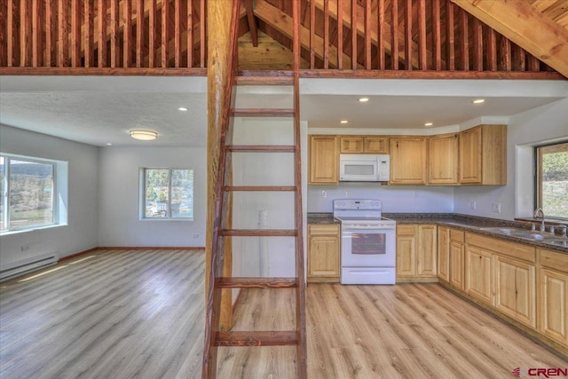 kitchen featuring baseboards, white appliances, a sink, and light wood-style floors