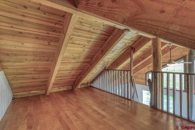 bonus room featuring wood ceiling, hardwood / wood-style flooring, and vaulted ceiling with beams