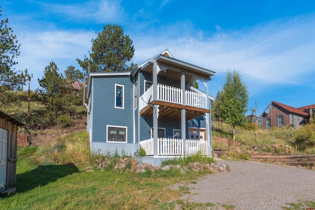 view of front of property with a balcony and a porch