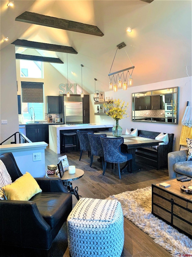 living area featuring high vaulted ceiling, dark wood finished floors, and beam ceiling