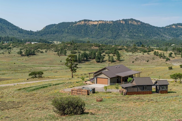 property view of mountains with a rural view and a view of trees