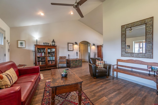 living area with high vaulted ceiling, arched walkways, ceiling fan, and wood finished floors