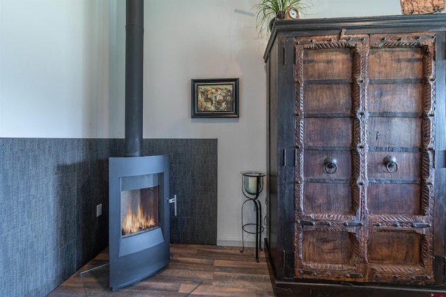 details featuring wood finished floors and a wood stove