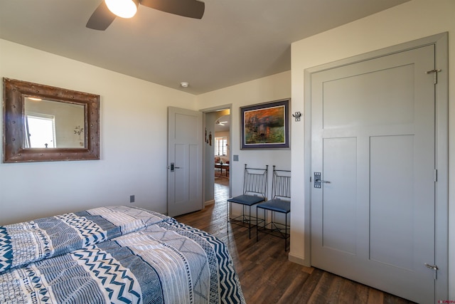 bedroom featuring multiple windows, a ceiling fan, and wood finished floors