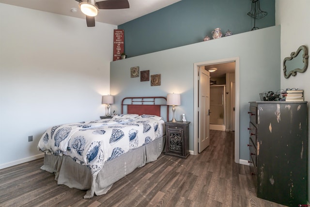 bedroom with a high ceiling, wood finished floors, and baseboards