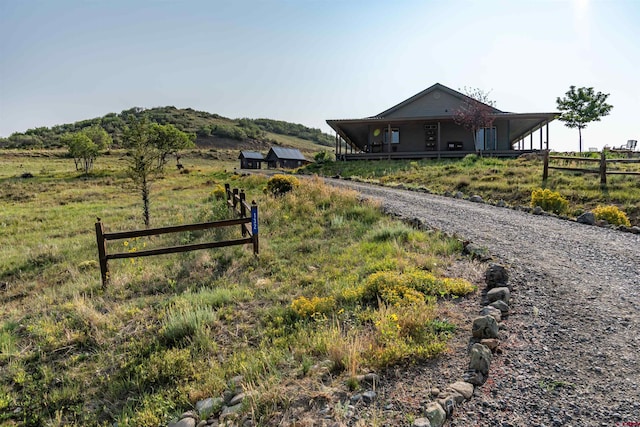 exterior space with a rural view and fence