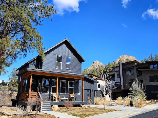 view of front of house with driveway and a porch