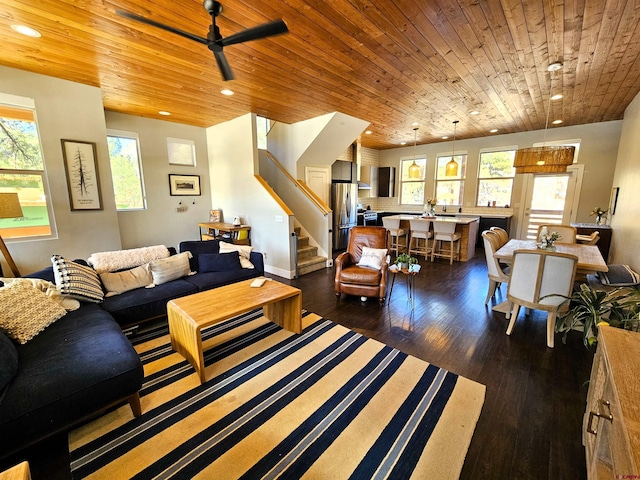 living area featuring dark wood finished floors, wooden ceiling, ceiling fan, stairs, and recessed lighting