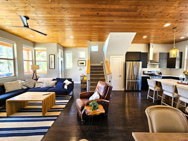 living area with stairs, dark wood-style flooring, and wooden ceiling