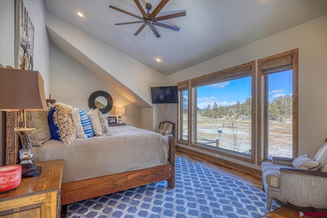 bedroom with a ceiling fan, lofted ceiling, recessed lighting, and wood finished floors