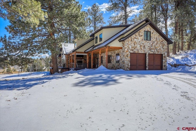 exterior space with stone siding and covered porch