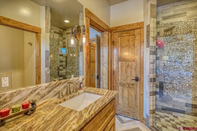 bathroom featuring a shower stall and vanity