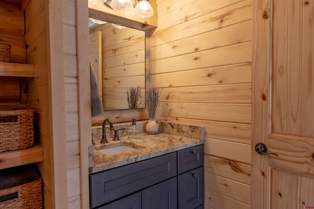 bathroom with wood walls and vanity