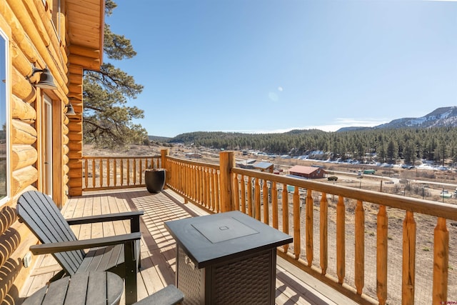 wooden terrace with a mountain view and a view of trees