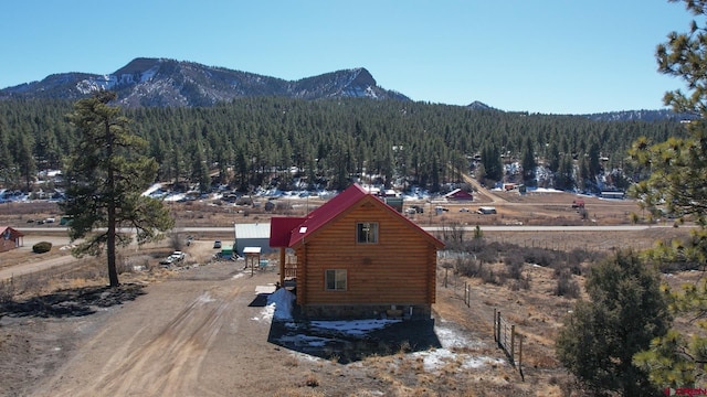 aerial view featuring a mountain view and a wooded view