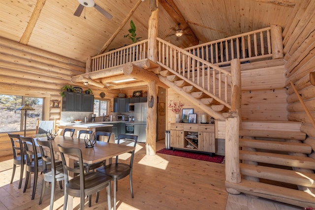 dining room featuring wood ceiling, light wood finished floors, and a ceiling fan