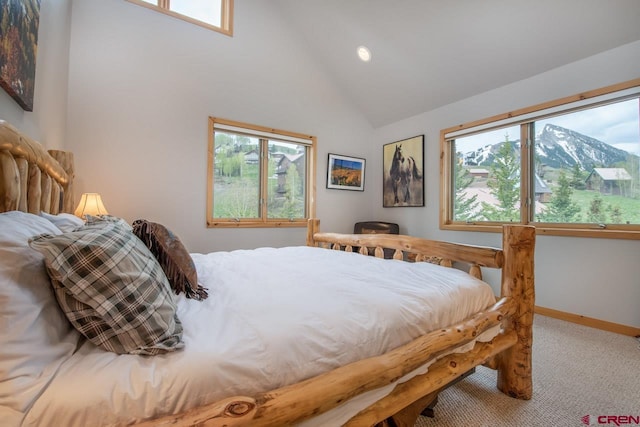 bedroom featuring carpet floors, multiple windows, high vaulted ceiling, and baseboards