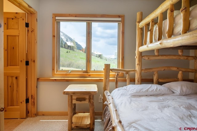 carpeted bedroom with baseboards