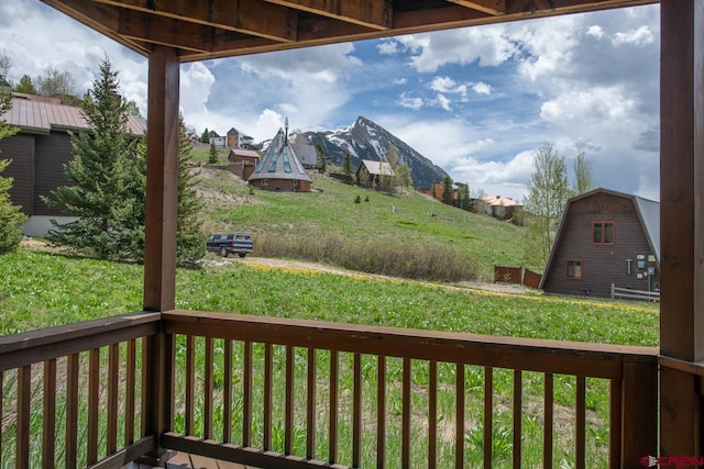 wooden terrace featuring a lawn