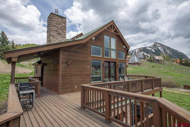 wooden deck featuring a mountain view