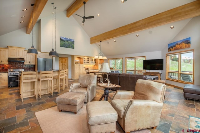 living area with beam ceiling, high vaulted ceiling, and stone tile flooring