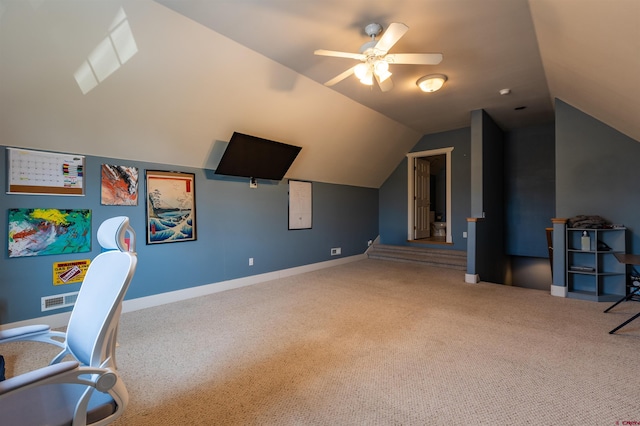 interior space with carpet, visible vents, a ceiling fan, vaulted ceiling, and baseboards