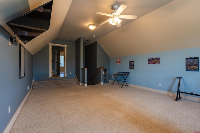 additional living space with lofted ceiling, carpet flooring, a ceiling fan, and baseboards