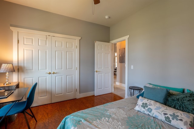 bedroom featuring ceiling fan, baseboards, a closet, and wood finished floors