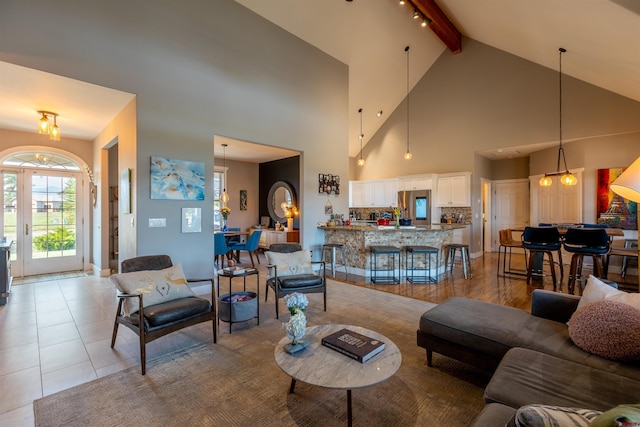 living room featuring vaulted ceiling with beams and light tile patterned flooring