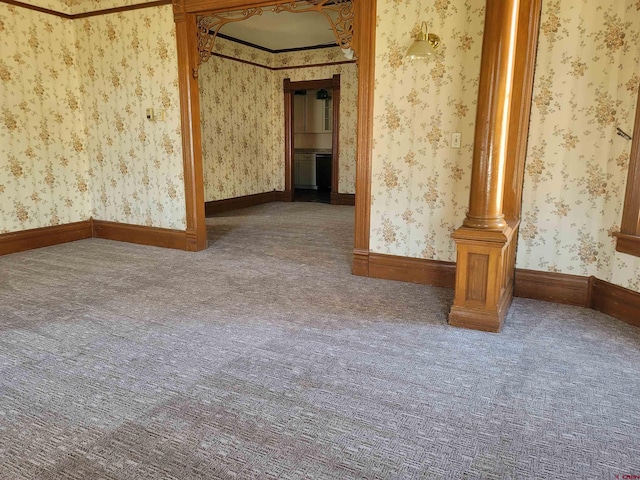 spare room with baseboards, carpet floors, and wallpapered walls