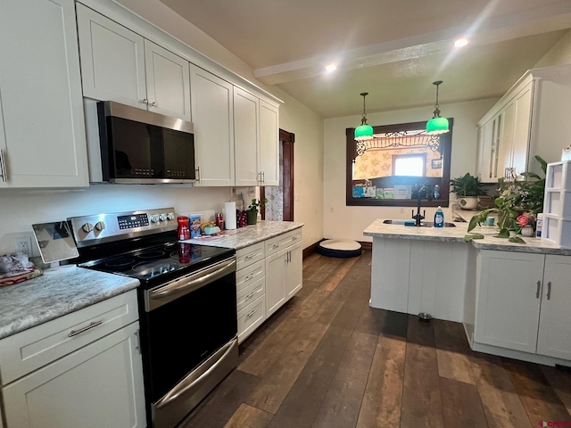 kitchen with stainless steel appliances, light countertops, dark wood-type flooring, white cabinetry, and a sink