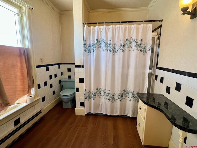 bathroom with toilet, tile walls, crown molding, and wood finished floors