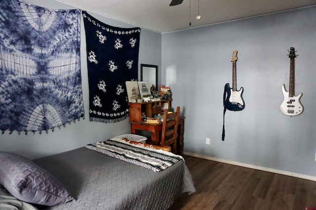 bedroom featuring ceiling fan, baseboards, and wood finished floors