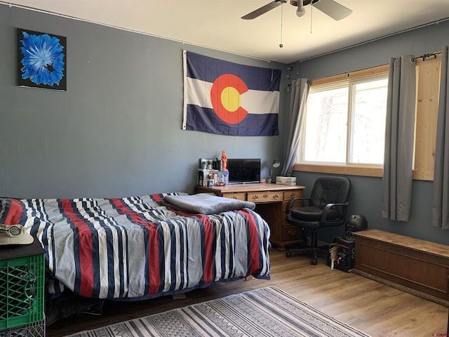 bedroom featuring wood finished floors and a ceiling fan