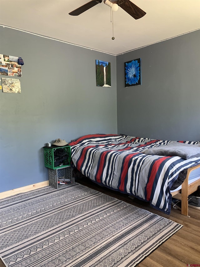 bedroom featuring a ceiling fan and wood finished floors