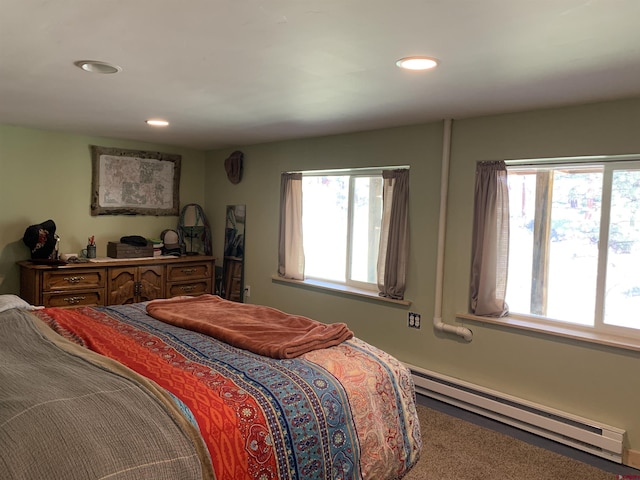 bedroom featuring a baseboard heating unit and recessed lighting